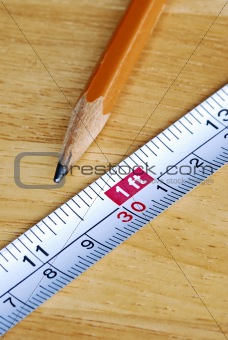 Measuring tape and pencil are tools for carpenters