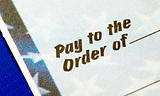 Close-up view of the phrase “Pay To The Order Of” isolated on blue