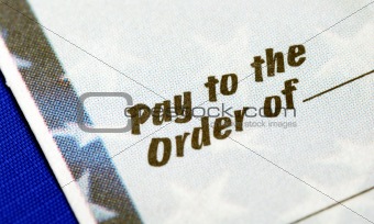 Close-up view of the phrase “Pay To The Order Of” isolated on blue