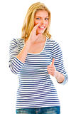 Smiling beautiful teen girl reporting good news and  showing thumbs up gesture

