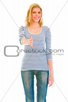 Smiling beautiful teen girl stretches out hand for handshake
