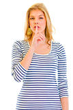 Alert beautiful teen girl  with finger at mouth. Shh gesture
