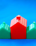 Row of toy houses isolated on blue