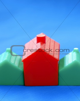 Row of toy houses isolated on blue