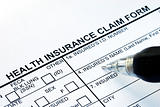 File the health insurance claim form with a pen