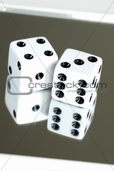 Two dices on the mirror isolated on white