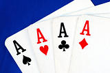 Four ace play cards isolated on blue