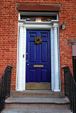 An old blue entrance door of a house