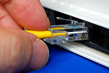 Plug the yellow network cable into the router isolated on blue
