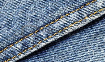 Denim material with seam running diagonally through the middle
