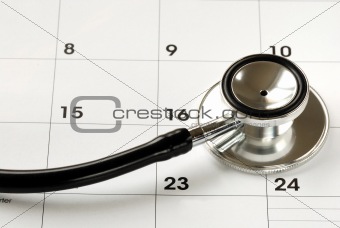 A stethoscope on the calendar concepts of medical appointment