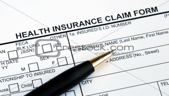 Filling the health insurance claim form with a pen