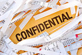 The word Confidential surrounded by some shredded papers