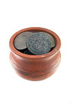 Old traditional clay mug with ancient coins