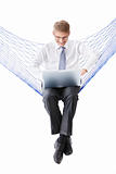 A man in a tie with a laptop in a hammock isolated