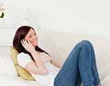 Beautiful red-haired woman having a conversation on the phone wh
