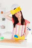 Beautiful red-haired woman cleaning a cutting board in the kitch