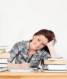 Attractive joyful red-haired girl studying for an examination