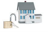 Miniature house and opened padlock