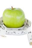 Closeup of a green apple circled with a tape measure