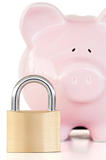 Close up of a pink piggy bank and padlock