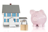 House locked with padlock and piggy bank