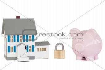 House locked with padlock and pink piggy bank