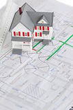 Close-up of toy house model and ruler on a plan