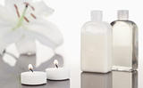 White orchid  glass flasks and lighted white candles