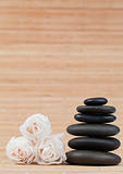 Roses and a black pebbles stack