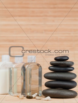 Glass flasks with pebbles and a black stones stack