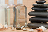 Close up of pebbles with a black pebbles stack and glass flasks