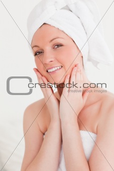 Cute young woman wearing a towel