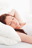 Close-up of a gorgeous red-haired woman sleeping in her bed