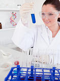 Attractive red-haired woman holding a test tube