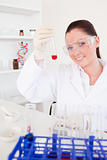 Charming red-haired woman holding a test tube