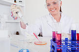 Gorgeous red-haired scientist using a pipette
