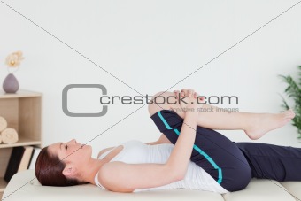 Athletic woman stretching her leg