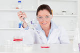Cute scientist looking at the camera while preparing a sample