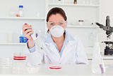 Young scientist preparing a sample wearing a mask
