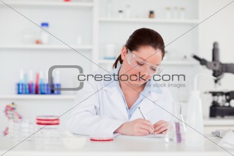 Young scientist writting a report