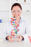 Young scientist showing the dna double helix model