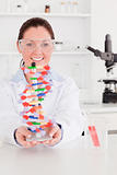 Portrait of a beautiful scientist showing the dna double helix m