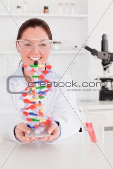 Portrait of a smiling scientist showing the dna double helix mod