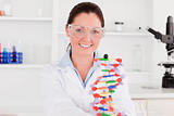 Smiling scientist showing the dna double helix model