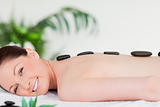 Smiling beautiful woman having a stone massage
