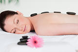 Young woman having a black stones massage