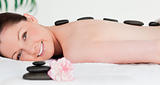 Red-haired woman receiving a hot stone massage