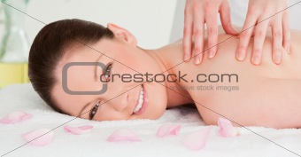 Beautiful woman having a massage while looking at the camera