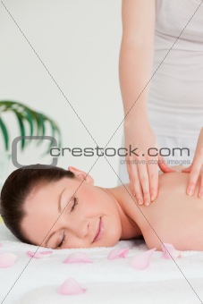 Portrait of a young woman closing her eyes during a massage
